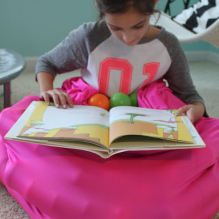 Sensory girl reading on ball bag